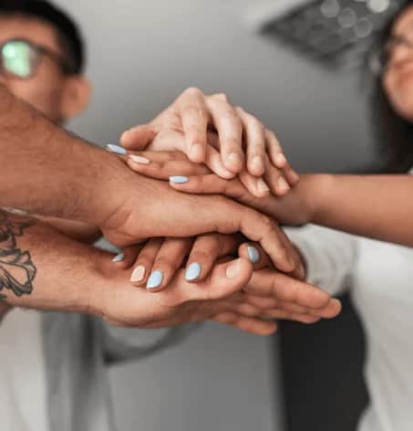 Photo of group stacking hands